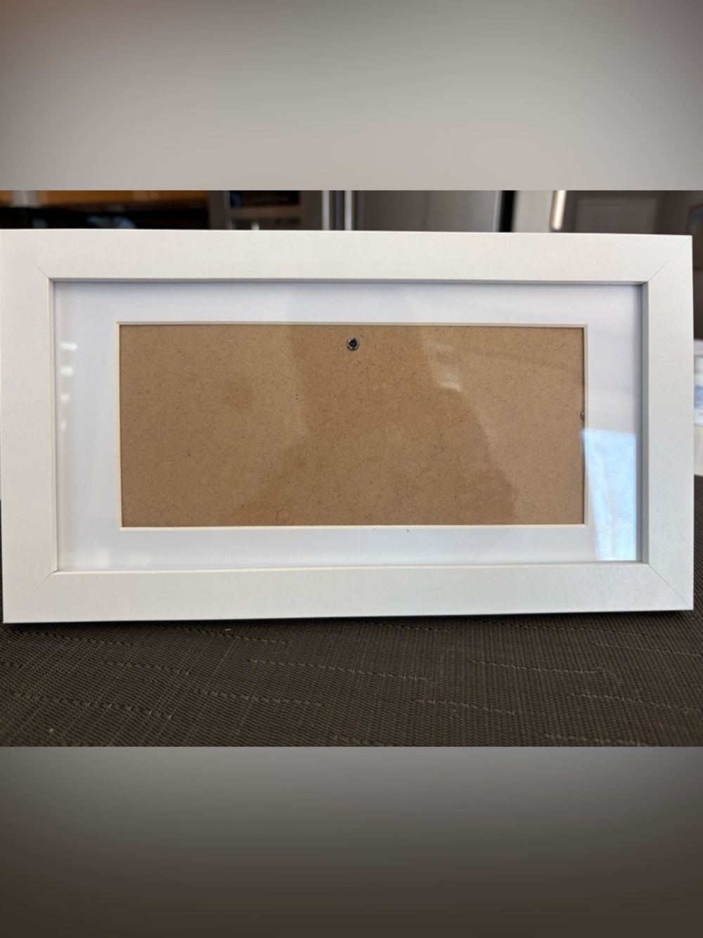 White picture frame with white mat. Holds up to 8 1/2”x 4 1/2” photo or document